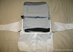 Shirts being wrapped around packing cube as part of bundle wrapping packing